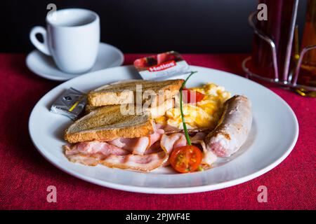 Plate with toast and bacon at breakfast time Stock Photo