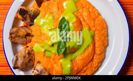 Organic sweet potato puree with aubergine chips. Stock Photo