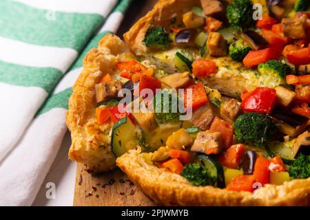Vegetarian tart with broccoli, pepper and zucchini in puff pastry. Stock Photo