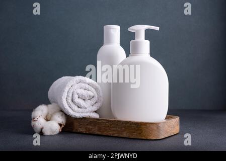 White empty shampoo or lotion bottle for mock-up in modern dark bathroom interior Stock Photo