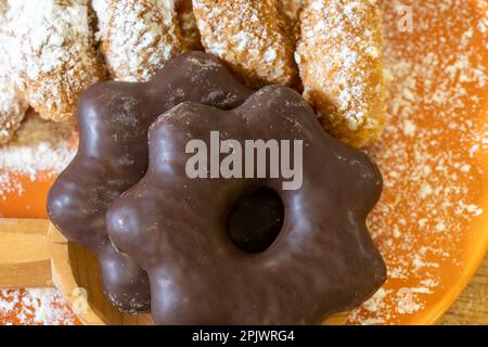 Chocolate covered treats on an orange plate Stock Photo