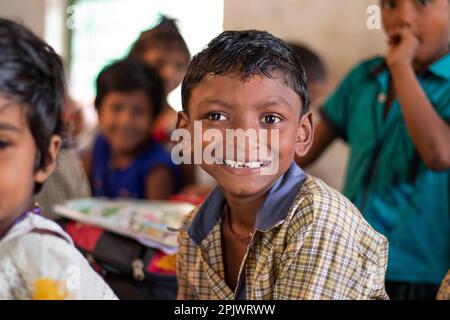 Happy school boy looking at camera in classroom Stock Photo
