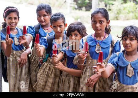 School Children's  eating an ice lolly in outdoot Stock Photo