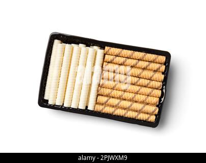 Chocolate and vanilla crunchy wafer rolls with cream filling in a package isolated on a white background top view. Stock Photo