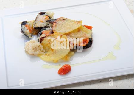 Rice, potatoes and mussels is a typical dish from the tradition of ...