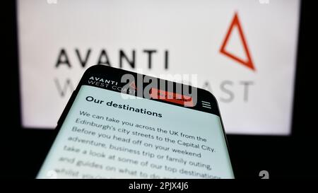 Smartphone with webpage of British train company Avanti West Coast on screen in front of business logo. Focus on top-left of phone display. Stock Photo
