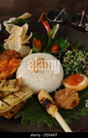 The typical dish of Balinese cuisine Nasi Champur (Mixed Rice), Ubud, Bali. Stock Photo