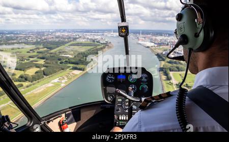 Helicopter flight. View from the cockpit with the pilot and flight instruments. Stock Photo