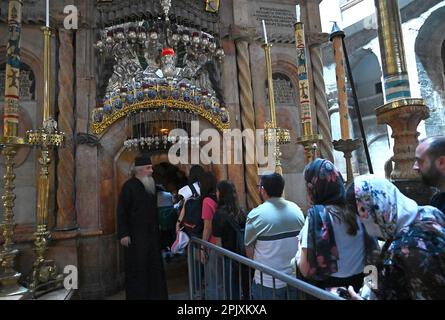 Old City Jerusalem, Israel. 04th Apr, 2023. A Greek Orthodox priest directs people entering the sepulchre in the Church of the Holy Sepulchre during Holy Week in the Old City of Jerusalem, on Tuesday, April 4, 2023. The Church of the Holy Sepulchre is believed to be the site of Jesus' crucifixion, burial and resurrection and the most sacred site for Christians. Photo by Debbie Hill/ Credit: UPI/Alamy Live News Stock Photo