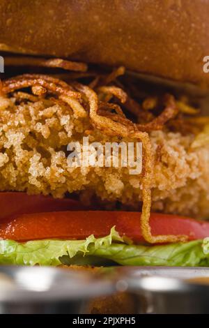Chicken burger served with french fries and sauces in a wooden case Stock Photo