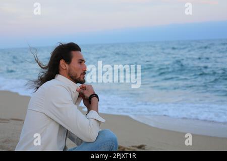 Long hair man beach Stock Photo