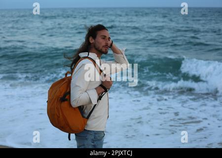 Long hair man beach Stock Photo
