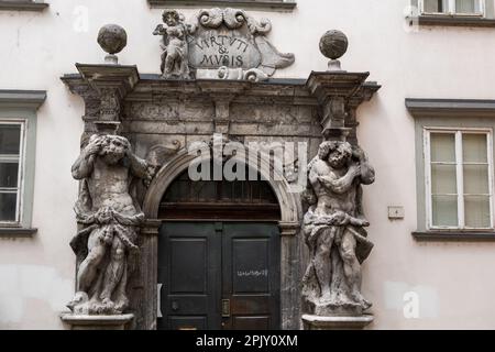 Slovenia, Ljubljana, Portal of Ljubljana Theological Seminary Palace Library, entrance with two sculptures of Atlas flanking the doorway. Portal work Stock Photo