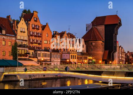 City of Gdańsk at dusk in Poland. The Old Town skyline with medieval Crane and footbridge over Motława river. Stock Photo