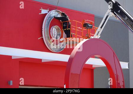 North Hollywood, California / USA - March 24, 2023: A Target bullseye logo is shown being installed above the entryway at a new retail location. Stock Photo