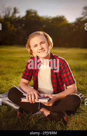 happy student boy study in green park, smiling and looking at camera. ready to passing exams Stock Photo