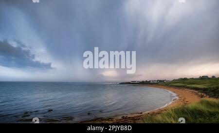 Thundery skies over Brora beach in Sutherland in the Highlands of Scotland Stock Photo