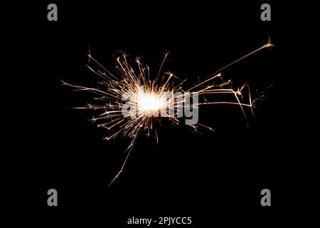 Burning sparkler isolated on black background. Fireworks theme. Light effect and texture. Christmas and new year decoration. Stock Photo