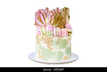 Beautiful pink and green cream cheese cake with rice paper, edible gold and macaroons. Delicious birthday cake isolated. Stock Photo