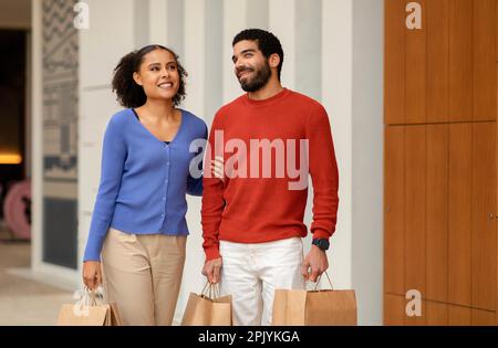 Happy Mixed Family Couple Shopping Together Enjoying Weekend Outside Stock Photo