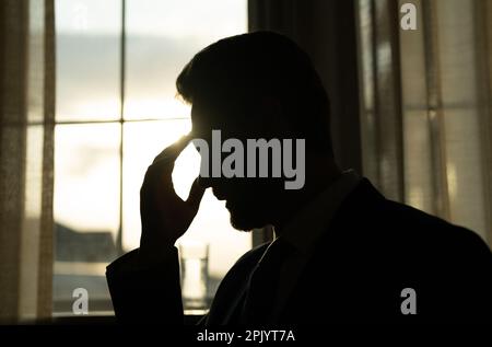 Tired, headache and eye strain from laptop. Businessman with stress, burnout and fatigue eyestrain. Business man rubbing tired eyes after computer Stock Photo