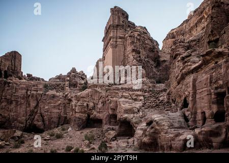 The Royal Tombs of Petra embody the unique artistry of the Nabateans while also giving display to Hellenistic architecture, but the façades of these tombs have worn due to natural decay. One of these tombs, the Palace Tomb, is speculated to be the tomb for the kings of Petra. The Corinthian Tomb, which is right next to the Palace Tomb, has the same Hellenistic architecture featured on the Treasury. The two other Royal Tombs are the Silk Tomb and the Urn Tomb; the Silk Tomb does not stand out as much as the Urn Tomb. The Urn Tomb features a large yard in its front, and was turned into a church Stock Photo