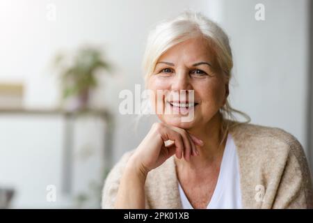 Portrait of smiling senior woman looking at camera Stock Photo