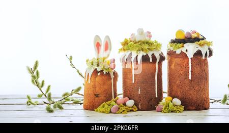 Paska - Easter Eve sweet bread with icing decorated with eatable "moss" still life with willow. Popular dessert during Eastern Orthodox Easter. Old cu Stock Photo