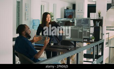 System engineers celebrating successful code compiling, doing highfive hand gesture after system development. Team of coders analyzing algorithm and creating app server interface. Stock Photo