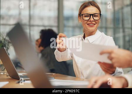 Close up of businesspeople working together with financial documents in office Stock Photo