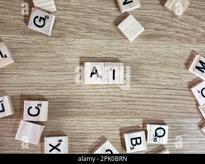The abrieviation AI spelled out in letter game pieces on a light wooden background Stock Photo