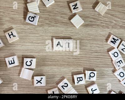 The abrieviation AI spelled out in letter game pieces on a light wooden background Stock Photo
