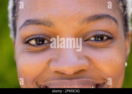 Closeup portrait of african american young woman smiling and looking at camera Stock Photo