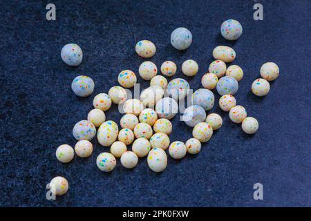 Random balls and pebbles abandoned on an external surface in the rain in downtown Vancouver Canada Stock Photo
