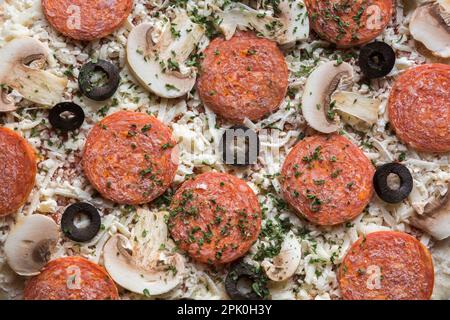 Frozen pepperoni and cheese pizza with black olives and white mushrooms, Studio Composition, Quebec, Canada Stock Photo