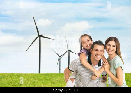 Happy family with child and view of wind energy turbines Stock Photo