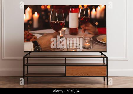 Scene of romantic movie on TV in room Stock Photo