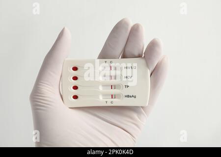 Doctor holding disposable express test for hepatitis on white background, closeup Stock Photo