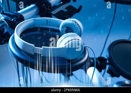 Modern headphones with illustration musical notes on light background, toned in blue Stock Photo