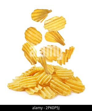Ridged crispy potato chips falling into heap on white background Stock Photo