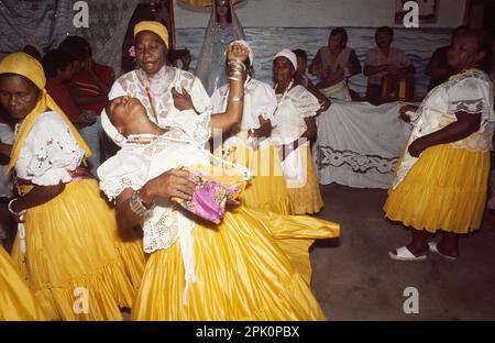 Tambor de Mina, syncretic Afro-Brazilian spirit possession religion. A 'filha de santo' (cult member) goes into a trance, possessed by a spirit. Stock Photo
