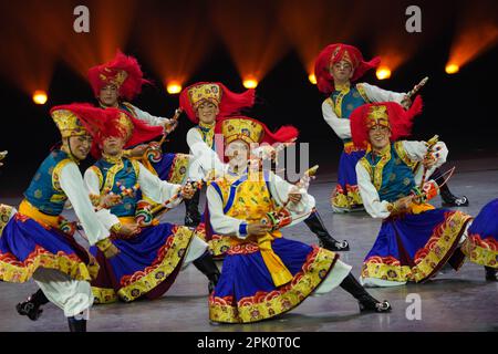 XICHANG, CHINA - APRIL 4, 2023 - Performers perform a group dance during the closing ceremony of the 9th Ethnic Arts Festival in Xichang, Sichuan Prov Stock Photo