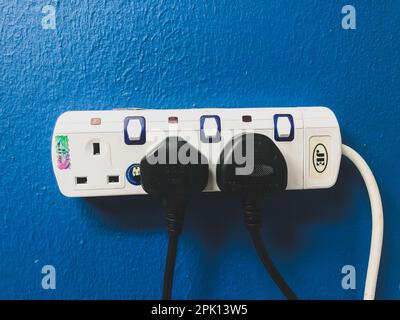 Klang, Malaysia: October 26, 2021- Blue wall with electric sockets and plugs Stock Photo