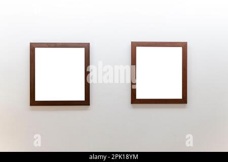 Blank wooden picture frames on concrete wall Stock Photo