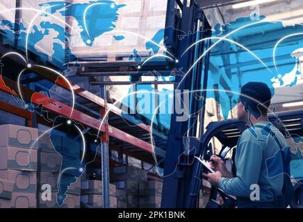 Worldwide logistics. Worker near forklift truck with cardboard boxes in warehouse and illustration of map Stock Photo