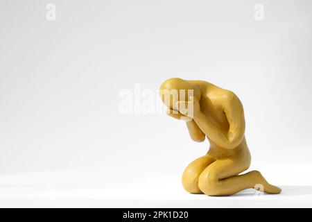 Plasticine figure of crying human on white background. Space for text Stock Photo