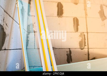 PVC window profile with a cuff and a blue mesh close-up on a blurred background Stock Photo