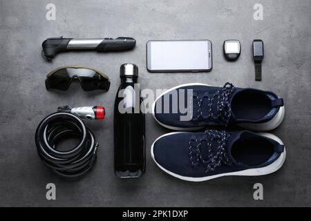 Flat lay composition with different cycling accessories on grey background Stock Photo