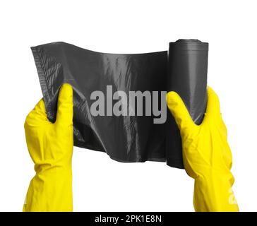 Person in rubber gloves holding roll of grey garbage bags on white background, closeup. Cleaning supplies Stock Photo