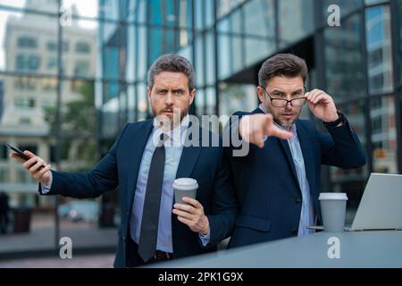 Business men aggressive outdoor. Conflict and business concept. Colleagues aggressive disputing having disagreement, diverse coworkers having conflict Stock Photo